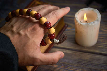 Monk uses wooden beads while prayingの写真素材
