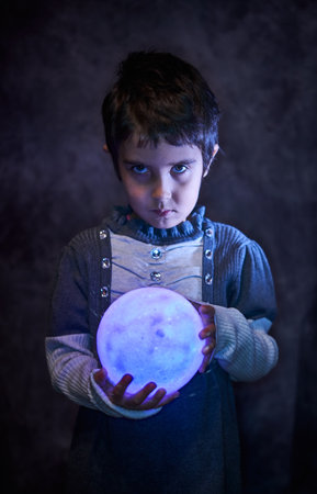 Cute little girl holds the tiny shiny Moonの写真素材