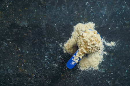 Protein powder, a full scoop of whey protein powder, sport nutrition for athletes and bodybuildersの写真素材