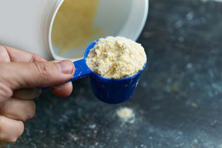 Protein powder, a full scoop of whey protein powder, sport nutrition for athletes and bodybuildersの写真素材