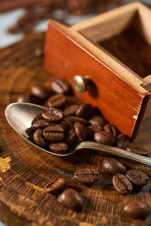 Coffee beans with wooden kitchen accessories on a rustic backgroundの写真素材