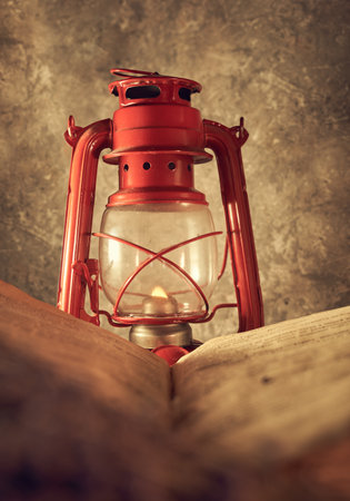 Vintage still life with an old kerosene lamp on a rustic backgroundの写真素材