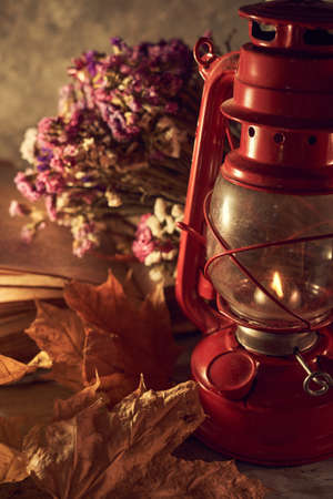 Vintage still life with an old kerosene lamp on a rustic backgroundの写真素材