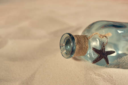 Pirate's bottle on the sand, old parchment, message in a bottleの写真素材