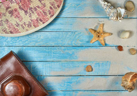 Summer still life on a wooden background, sea shells, glasses, starfishの写真素材