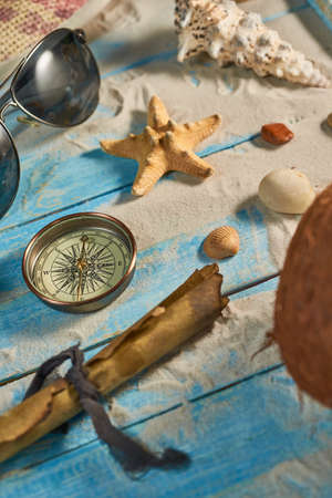 Summer still life on a wooden background, sea shells, glasses, starfishの写真素材