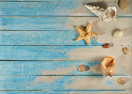 Summer still life on a wooden background, sea shells, glasses, starfishの写真素材