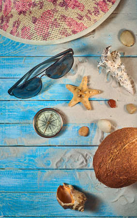 Summer still life on a wooden background, sea shells, glasses, starfishの写真素材