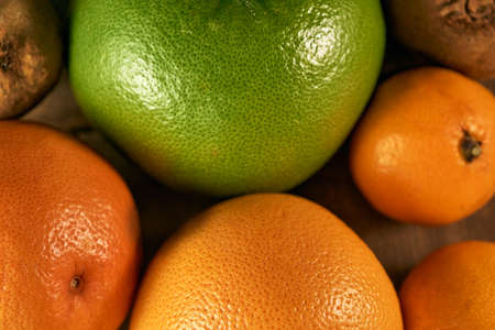 Multiple citrus fruits on a wooden backgroundの写真素材