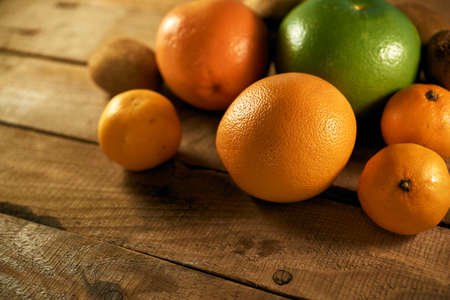 Multiple citrus fruits on a wooden backgroundの写真素材