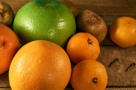 Multiple citrus fruits on a wooden backgroundの写真素材