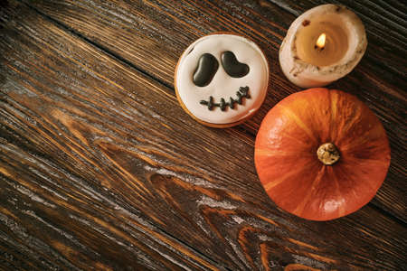 Halloween still life with scary cookies, candle and pumpkinsの写真素材