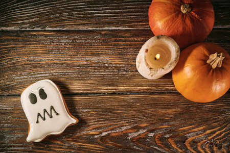 Halloween still life with scary cookies, candle and pumpkinsの写真素材