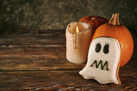 Halloween still life with scary cookies, candle and pumpkinsの写真素材