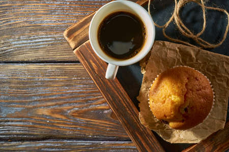 Morning coffee with sweet muffin on a kitchen black board