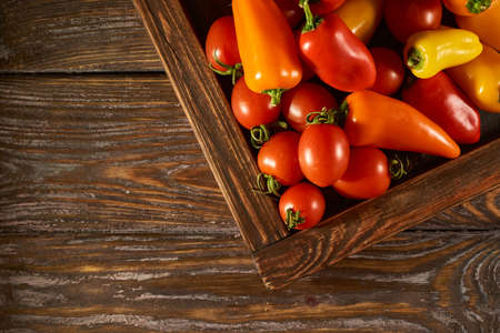 Mix of peppers and cocktail tomatoes on a kitchen black boardの写真素材