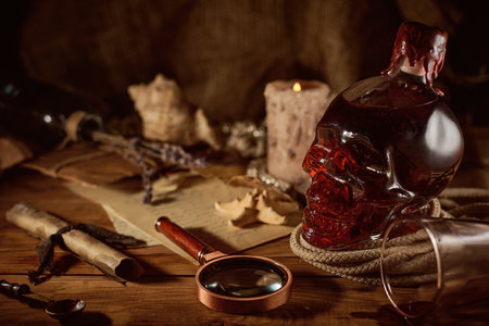 Old magic still life with a bottle of rumand a magnifying glassの写真素材