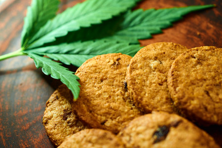 Cannabis cookies with marijuana leaf on wooden background. Close up.の写真素材