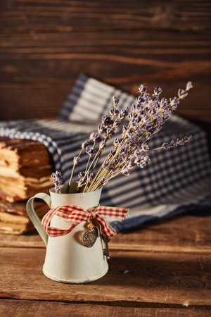 Bouquet of lavender flowers in a jug on a wooden backgroundの写真素材