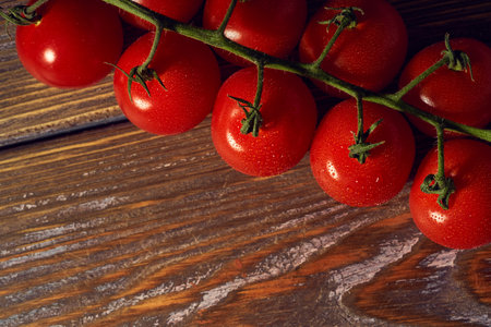 Cherry tomatoes on wooden background. Top view. Copy space.の写真素材
