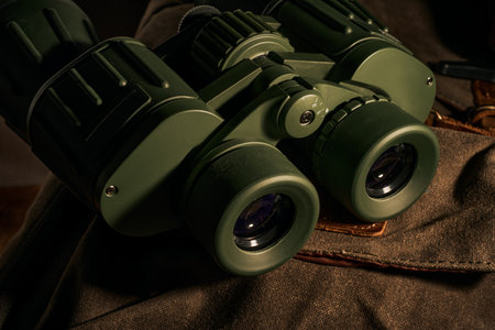 Green binoculars on a brown background. Close-up.の写真素材