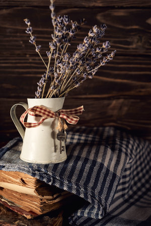Still life with lavender bouquet and old book on wooden backgroundの写真素材