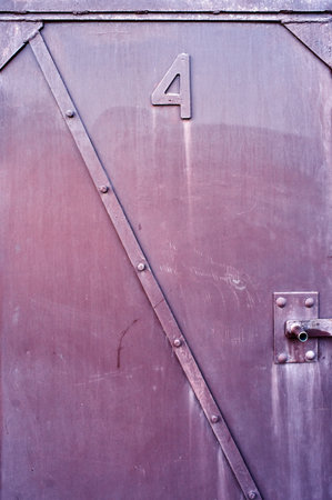 Vintage metal door with number 4 on it, closeup of photo
