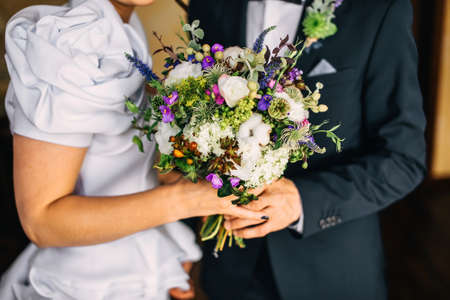 Groom hugs bride. bridal bouquetの写真素材