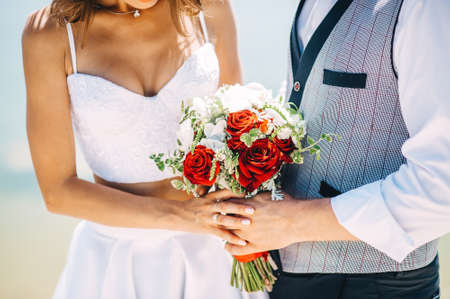 Groom hugs bride. bridal bouquetの写真素材
