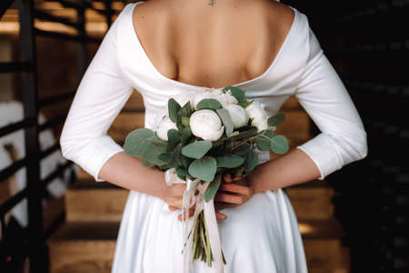 Brides wedding bouquet in women's hands. wedding flowersの写真素材