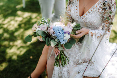 Brides wedding bouquet in women's hands. wedding flowersの写真素材