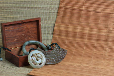 Chinese traditional nephrite jewelry on the bamboo mat background. still-life. copy spaceの写真素材