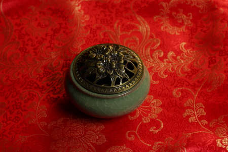 still life in Chinese style. incense burner and isolated on red background.の写真素材
