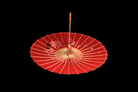 Chinese, Japanese, Oriental red umbrella on black background. Copy spaceの写真素材