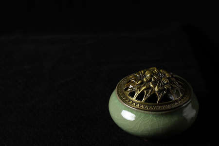 still life in Chinese style. incense burner and isolated on black background.の写真素材