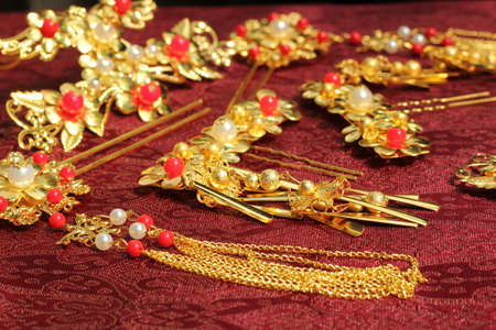 Chinese traditional hairpins hair clips Traditional Chinese women's jewelry. Gold hairpins with red gems. darck red background.の写真素材