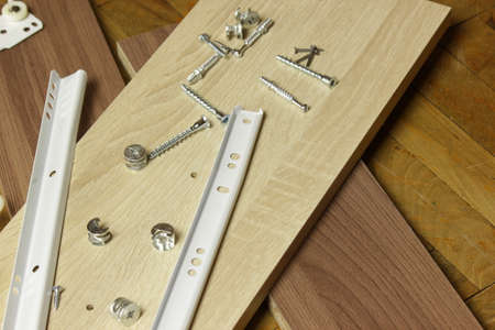 Roller guides for installation during furniture assembly, background.