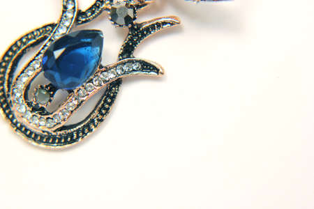 Oriental Turkish women's jewelry with blue gem in the form of a tulip on a white background.の写真素材