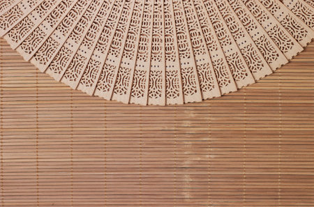 Chinese style wooden fan on bamboo texture background.の写真素材