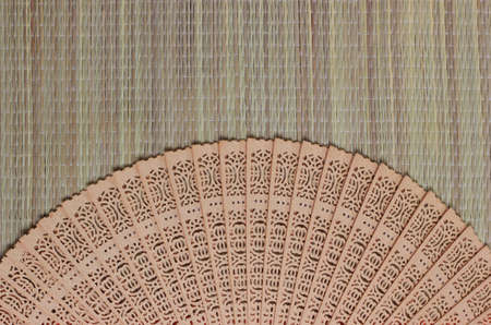 Chinese style wooden fan on bamboo texture background.の写真素材