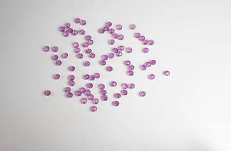 purple plastic beads on a white, gray backgroundの写真素材