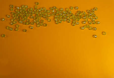 Green beads on a yellow backgroundの写真素材