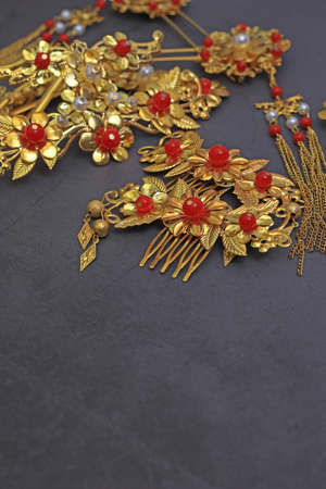 Chinese traditional hairpins hair clips on a gray concrete background. Traditional Chinese women's jewelry, gold hairpins with red gems.の写真素材