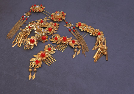 Chinese traditional hairpins hair clips on a gray concrete background. Traditional Chinese women's jewelry, gold hairpins with red gems.の写真素材