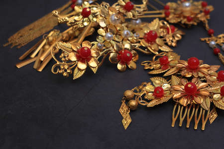 Chinese traditional hairpins hair clips on a gray concrete background. Traditional Chinese women's jewelry, gold hairpins with red gems.の写真素材