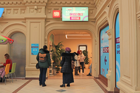 Moscow. Russia. December 8, 2021. Vaccination against covid 19 in the GUM shopping center. Russian text: "Vaccination against Covid 19 is carried out here".のeditorial素材