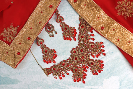 Indian red sari fabric and jewelry on a light background. wedding dressの写真素材
