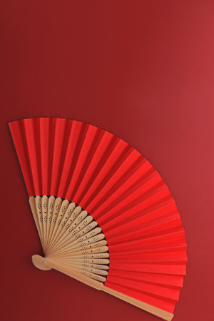 A red hand fan on a red background. Chinese, Japanese, Asian backgroundの写真素材