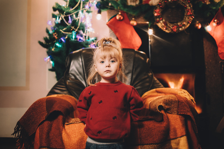 The little girl standing. Pre-Christmas mood. New Year soonの写真素材