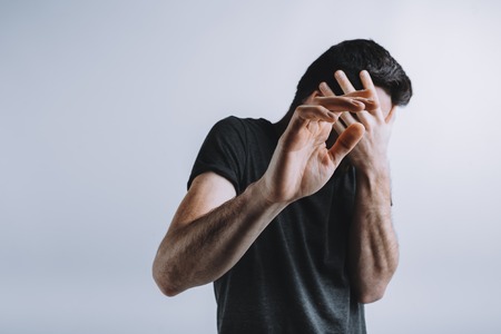 Man trying to protect himself with his armsの写真素材